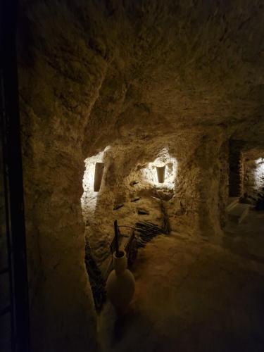 a dark room with a cave with stairs and lights at El Granero de Manzanares in Manzanares
