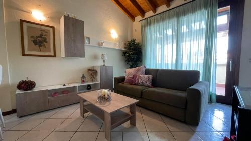 a living room with a couch and a table at Poggio al sole in Manerba del Garda