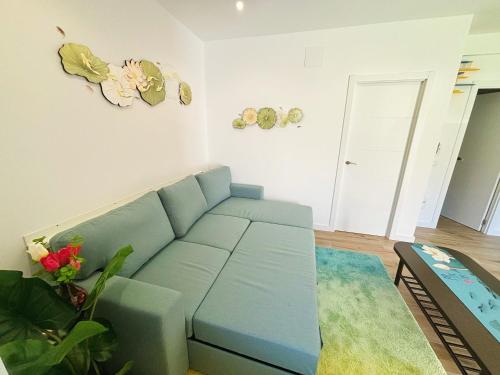 a living room with a blue couch in a room at Casa Postiguillo in Manzanares el Real