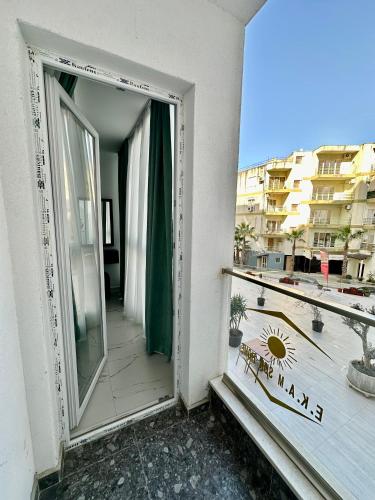 a mirror on the side of a building with a balcony at EKAM Sun Apartments in Golem