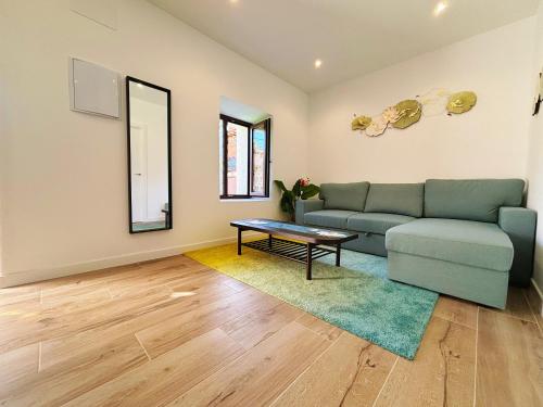 a living room with a couch and a table at Casa Postiguillo in Manzanares el Real