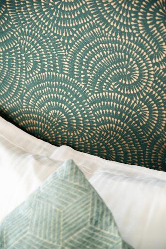 a close up of a bed with white sheets at Centre Jean XXIII in Annecy