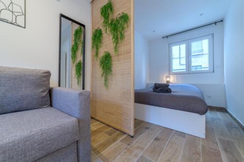 a bedroom with a bed and a mirror and a chair at Pasteur Collection - Moderne & Cosy - 3pers in Villeurbanne