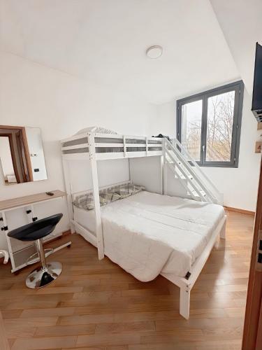 a bedroom with a white bunk bed and a desk at Bed & Bergamo Casa Vacanze in Bergamo