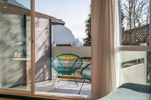 a room with a window and a chair on a balcony at Centre Jean XXIII in Annecy