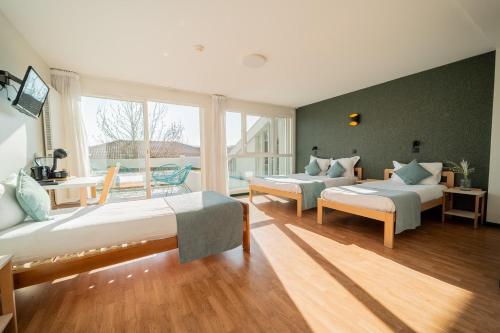 a large room with two beds and a window at Centre Jean XXIII in Annecy