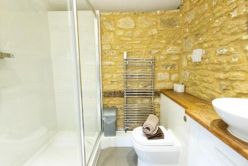 a bathroom with a shower and a toilet and a sink at Mouse House at Tove Valley Cottages in Towcester