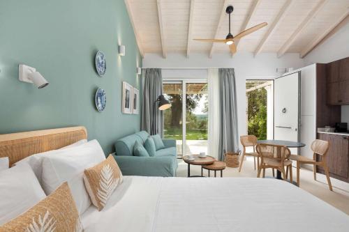 a bedroom with a bed and a living room at Corfu OliveStone Village with Swimming pool in Ágios Márkos