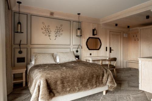 a bedroom with a large bed and a table at Willa na Kozińcu in Zakopane