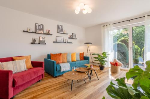 a living room with two couches and a table at Elegant Eifel Studio I Hiking I Kitchen I Terrace in Daun