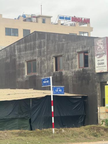 a building under construction with two street signs in front at Nhà nghỉ Bình An in Ðông Tác (1)