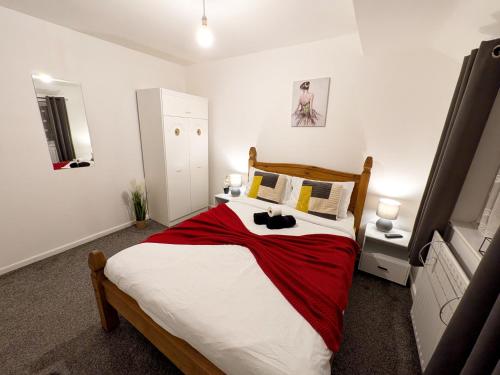 a bedroom with a large bed with a red blanket at Stay Sleep Rest Heeley, Sheffield in Heeley