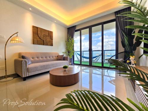 a living room with a couch and a table at Cozy Seaview Suite Johor Bahru CIQ in Johor Bahru