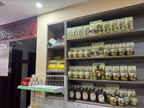 a store shelf filled with lots of jars of food at Bảo Trân Boutique Motel gần Sân Bay Và Trung Tâm in Da Nang