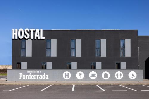 a building with a hospital sign in a parking lot at AS Hoteles Ponferrada in Columbrianos