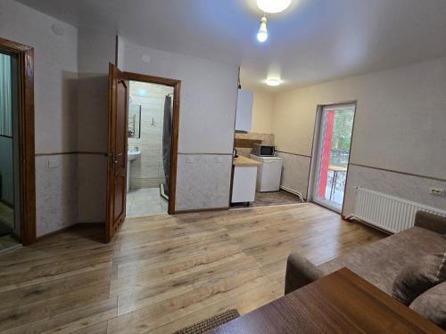 an empty living room with a couch and a kitchen at Апартаменти-студіо в Трускавці in Truskavets