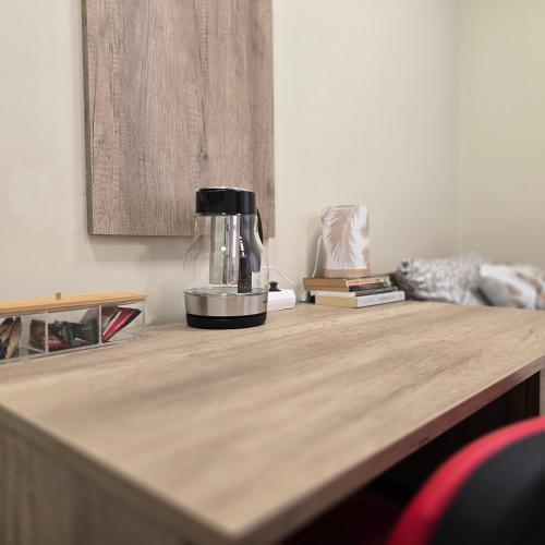 a coffee maker sitting on top of a wooden table at MA DONNA rooms in Floreşti