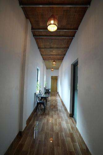 a hallway with chairs and a ceiling with a light at Phong Nha Magic Fingers Homestay and Spa in Phong Nha