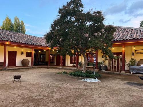 a house with a yard with a tree in front of it at CASONA SAN PEDRO Hotel Boutique in San Javier