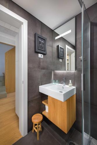 a bathroom with a sink and a mirror at Villa Artes with Free Hot Tub & Sauna in Branik