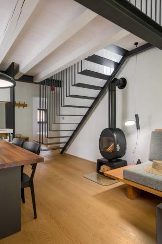 a living room with a fireplace and a staircase at Villa Artes with Free Hot Tub & Sauna in Branik