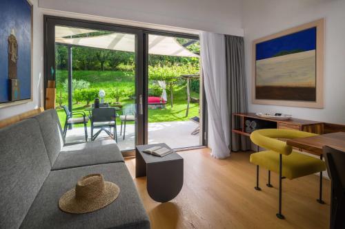 a living room with a couch and a table at Villa Artes with Free Hot Tub & Sauna in Branik