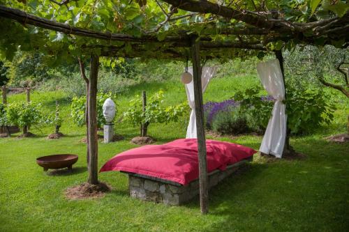 a bed under a canopy in a garden at Villa Artes with Free Hot Tub & Sauna in Branik