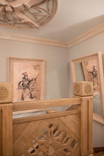 a room with a wooden staircase with paintings on the wall at Willa na Kozińcu in Zakopane