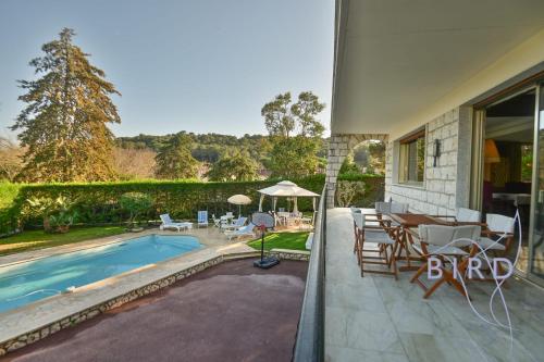 une maison avec une piscine, une table et des chaises dans l'établissement Magnificent residence with swimming pool and garden in Mougins, à Mougins
