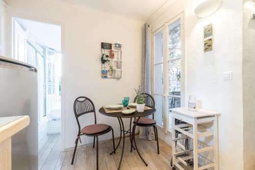 une petite cuisine avec une table et deux chaises dans l'établissement Atypical apartment old town in Cannes large terrace, à Cannes