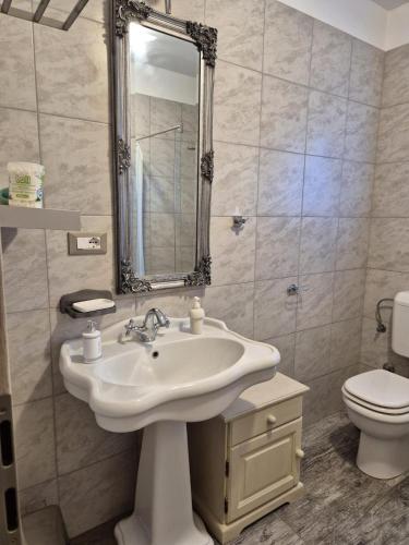 a bathroom with a sink and a toilet at K-Rooms in Veli Iž