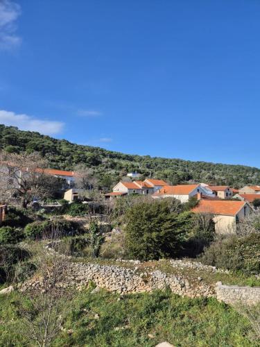 a group of houses on a hill in a town at K-Rooms in Veli Iž