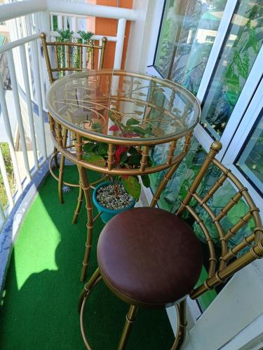 a glass table and a chair on a balcony at Uncle's Tagaytay Staycation in Iruhin