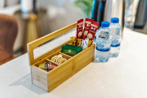 a wooden box with a bottle of water and snacks at Yas Escape -2BR by SLV in Abu Dhabi
