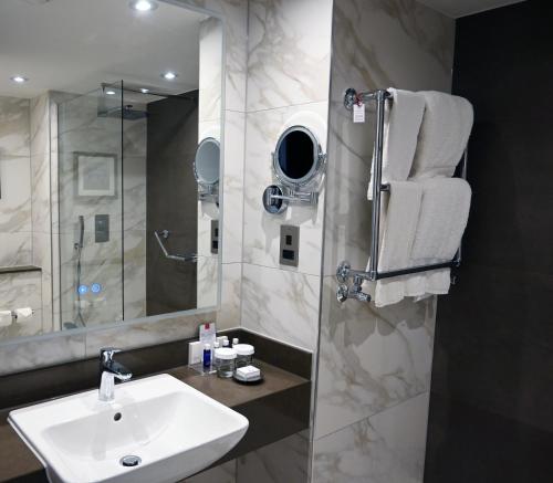 a bathroom with a sink and a shower at The Lowry Hotel Manchester in Manchester