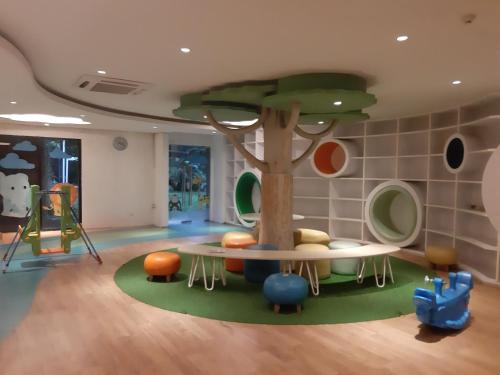 a childrens play room with a tree in the middle at Veladiena - Vimala Hills in Gadok 1