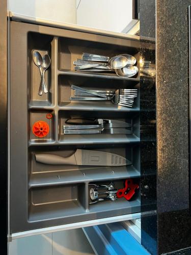 a drawer in a cabinet filled with utensils at RN Studios Premium Apt 805 - Mandi Hospitalidade in Maceió