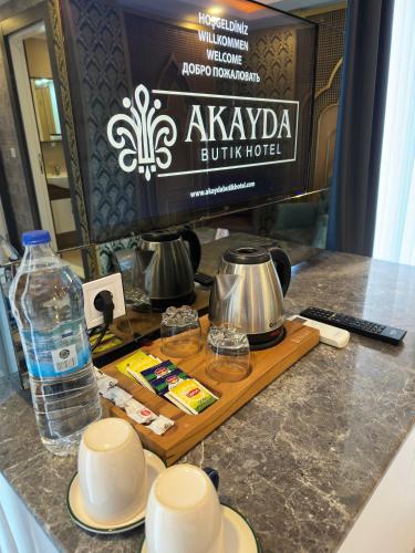 a table with a television and a bottle of water at Akayda Butik Hotel in Side