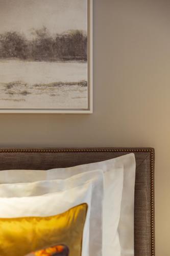 a picture hanging on a wall next to a pillow at Corinthia Grand Hotel Astoria Brussels in Brussels