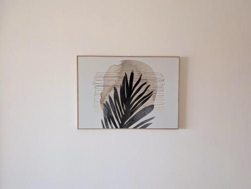 a picture of a plant on a white wall at SeafrontView - Cozy T1 Apartment 2 in Praia