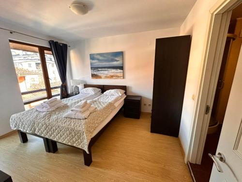 a bedroom with two beds and a window at Predela 2 Aparthotel in Bansko