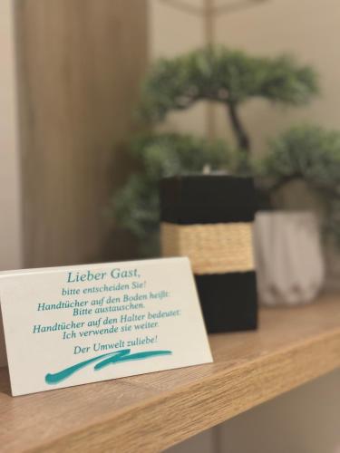 a sign sitting on top of a shelf with a plant at Gaststätte Zum Torkrug in Magdeburg