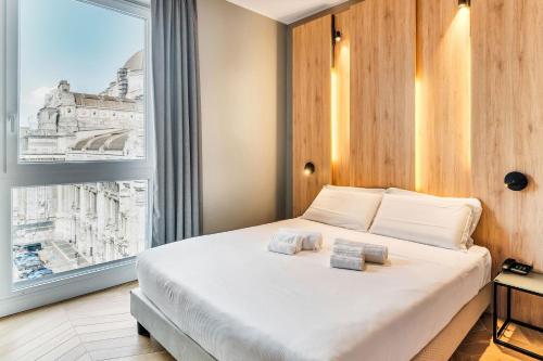 a bedroom with a large bed and a large window at B&B Hotel Milano Aosta in Milan