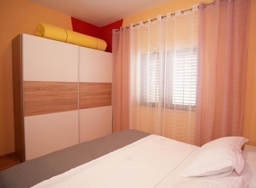 a bedroom with a bed and a window at Apartment Beky in Podstrana