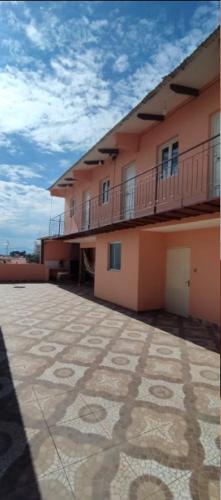 a large building with a balcony and a tile floor at Habitaciones en Zona Céntrica in Tarija