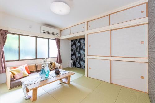 a living room with a couch and a table at Zen Home AKABANE in Tokyo