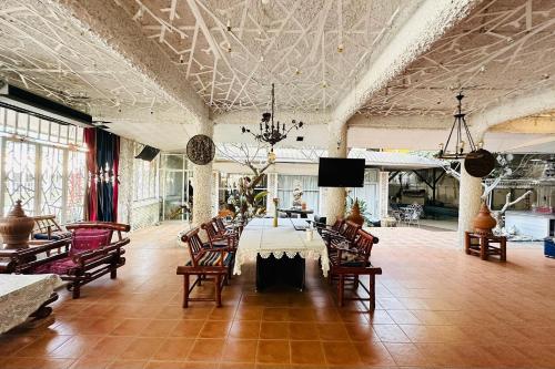 a large room with a table and chairs in it at I Am Chiang Rai in Ban Cham Bon