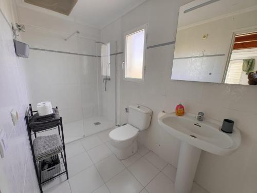 a white bathroom with a toilet and a sink at Studio tipo Loft con vista al Montgo in Denia