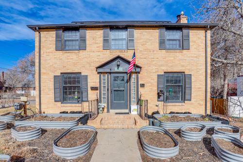 a brick house with a flag in front of it at Half-Mi to UNC Historic Dtwn Greeley Home in Greeley