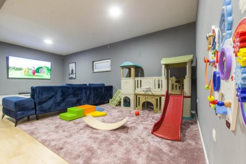 a play room with a couch and a play set at Villa Violet with Salt water pool in Makarska